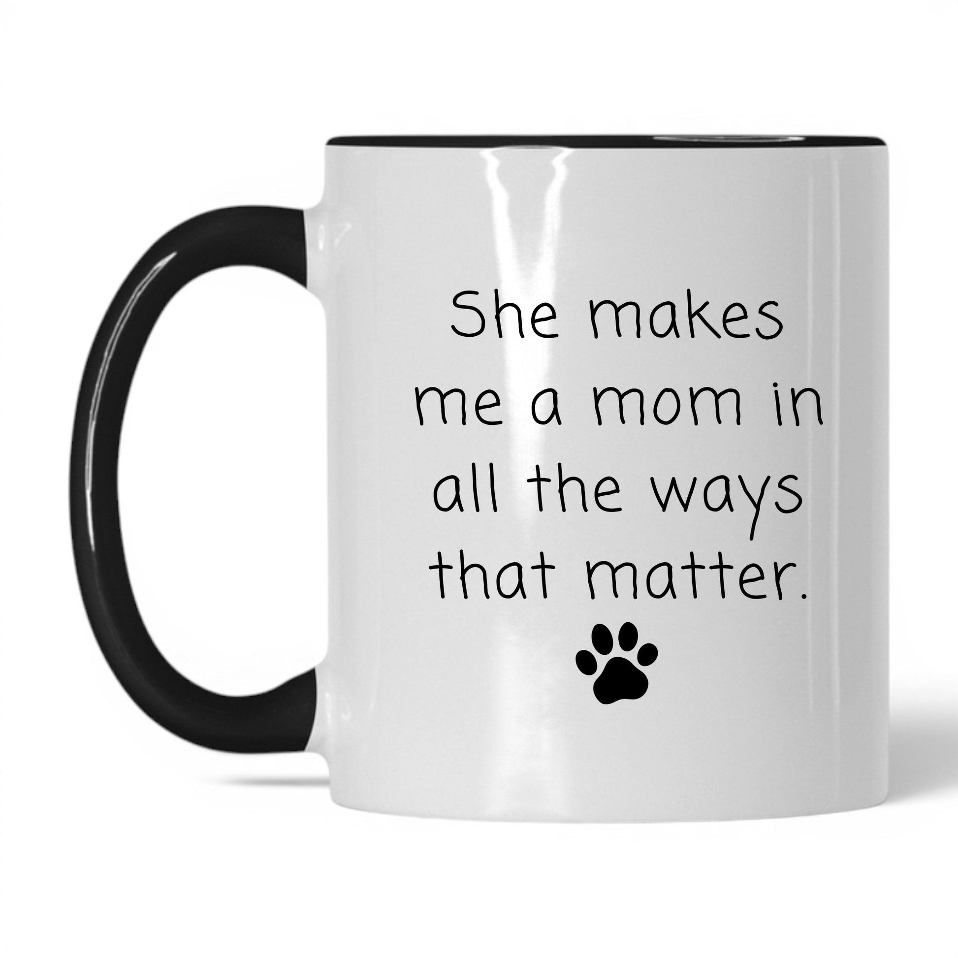 She Makes Me a Mom Mug – 11oz White/Black Mug