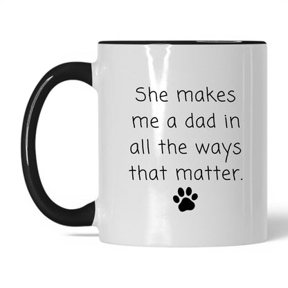 She Makes Me a Dad Mug – 11oz White/Black Mug