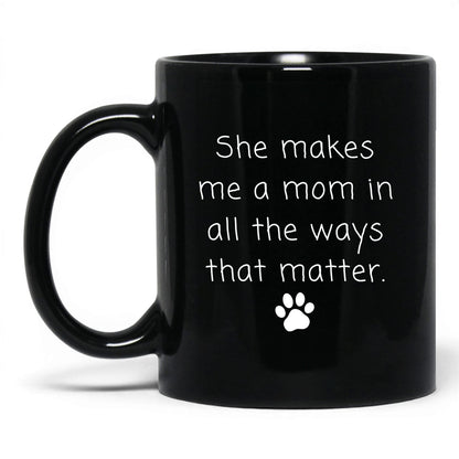 She Makes Me a Mom Mug – 11oz Black Mug
