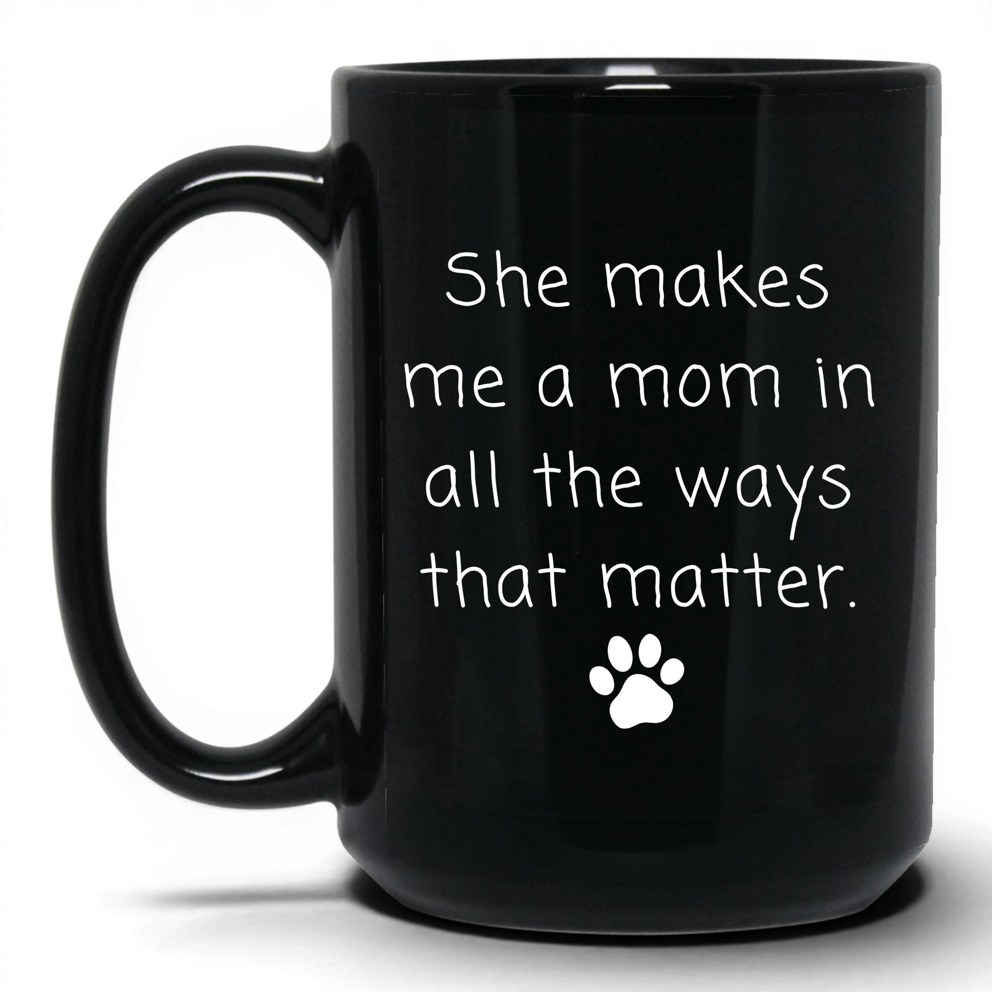 She Makes Me a Mom Mug – 15oz Black Mug