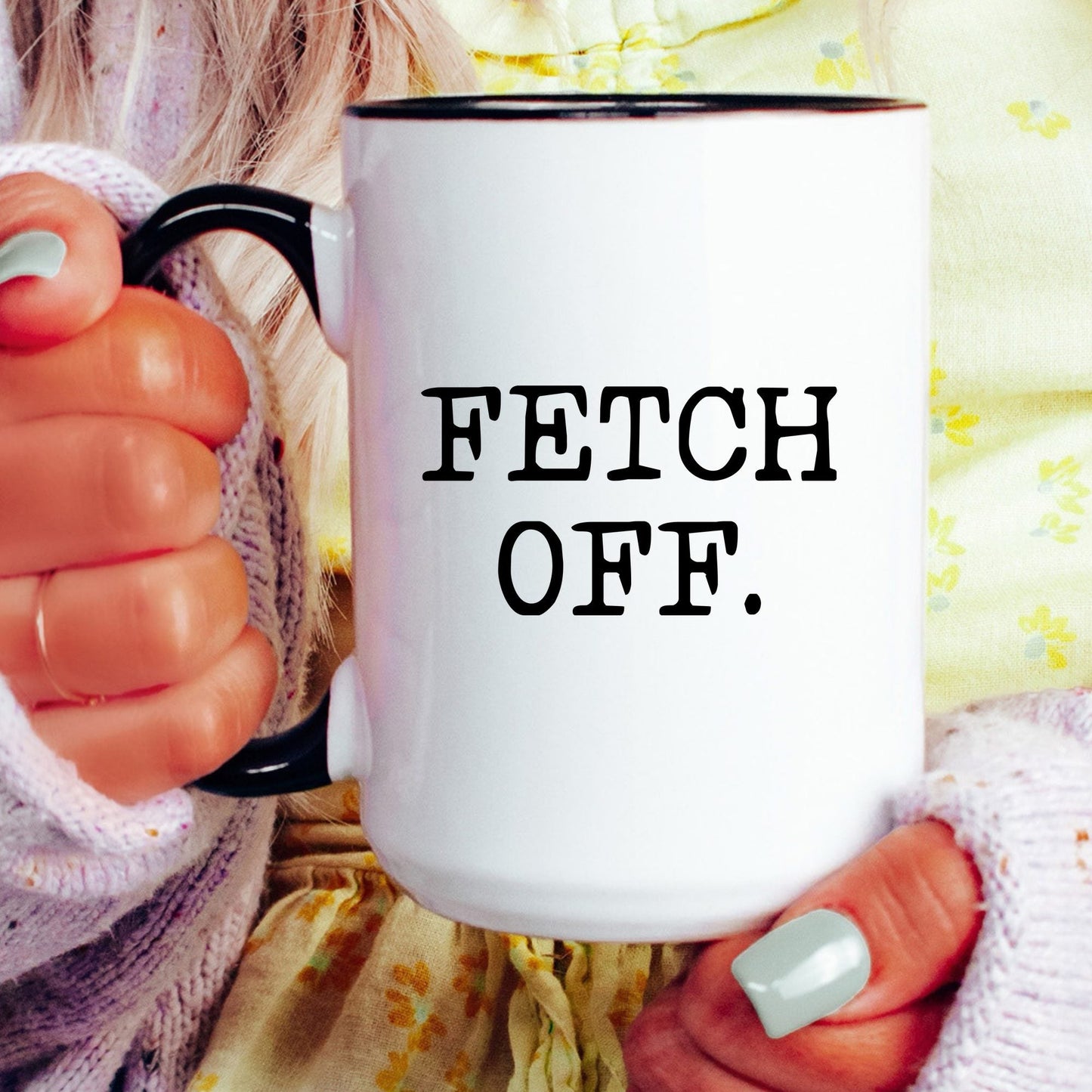 Fetch Off coffee mug held by a model