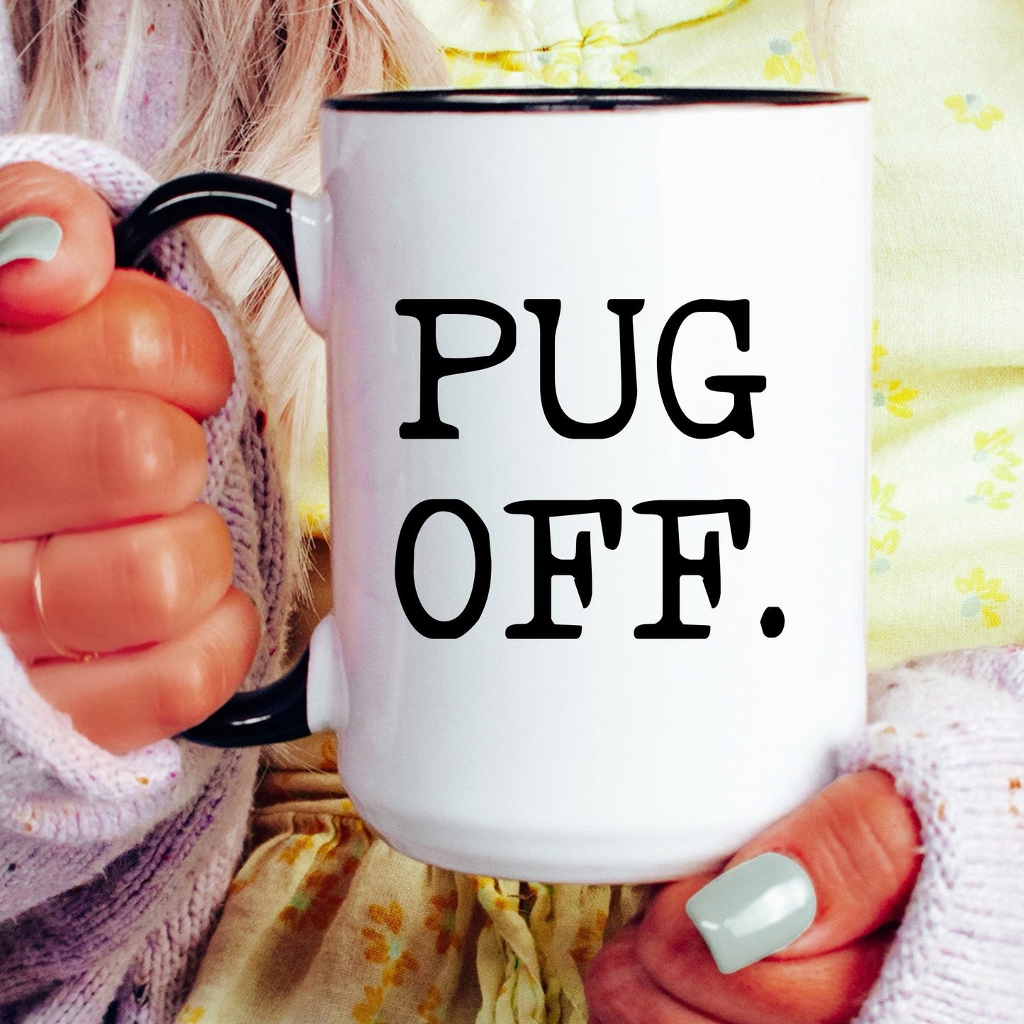 Pug Off coffee mug held by a model
