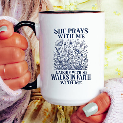 She Prays With Me, Laughs With Me, Walks in Faith With Me coffee mug held by a model