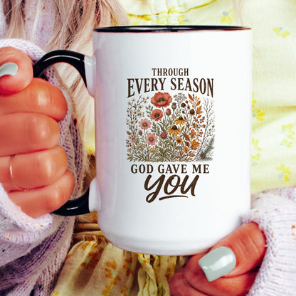 Through Every Season, God Gave Me You coffee mug held by a model