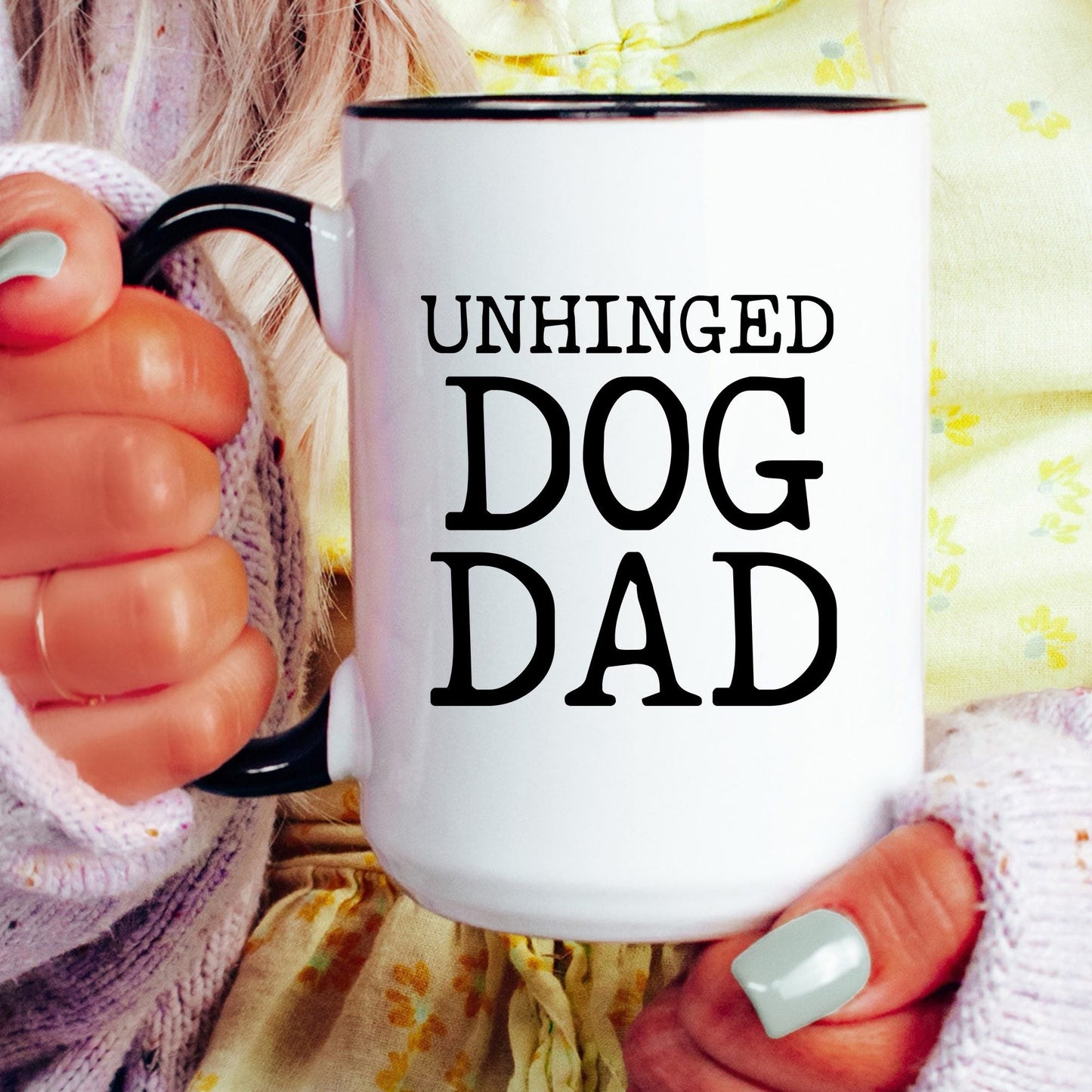 Unhinged Dog Dad coffee mug held by a model