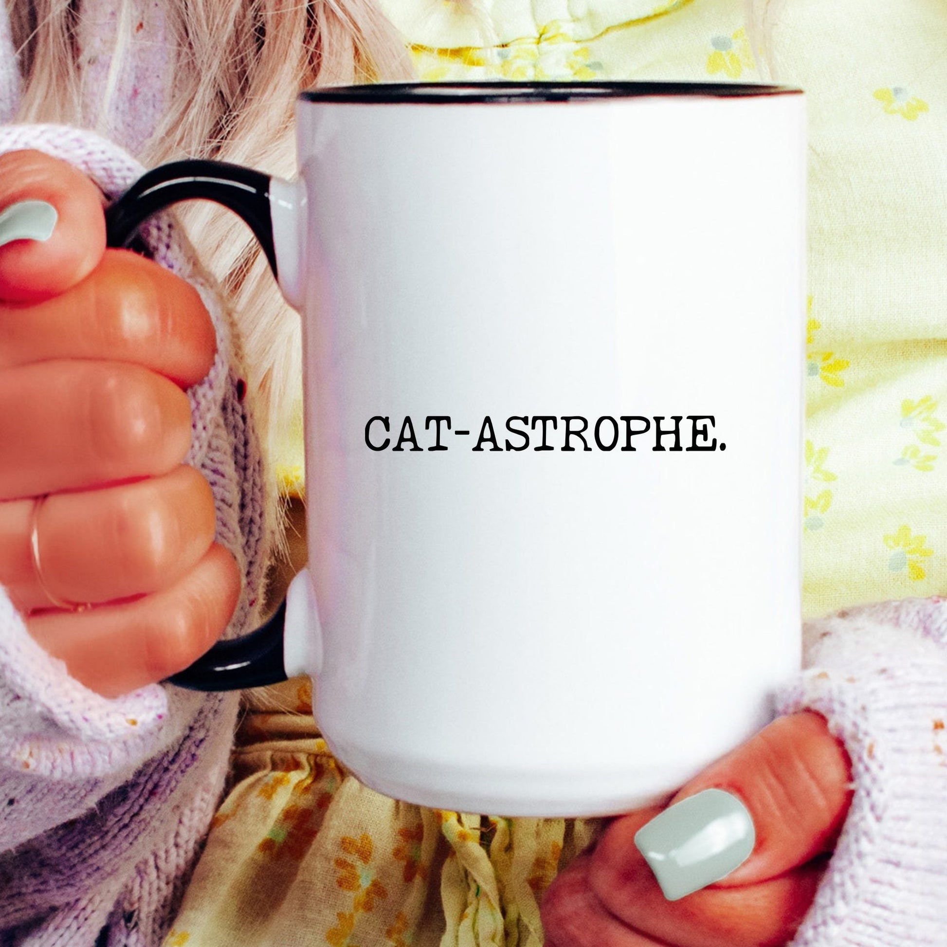Cat-astrophe coffee mug held by a model
