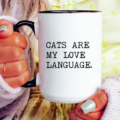 Cats Are My Love Language coffee mug held by a model