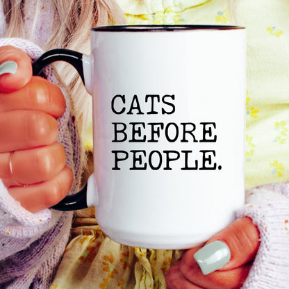 Cats Before People coffee mug held by a model