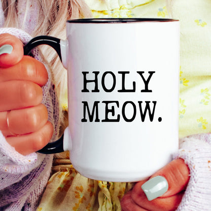 Holy Meow coffee mug held by a model
