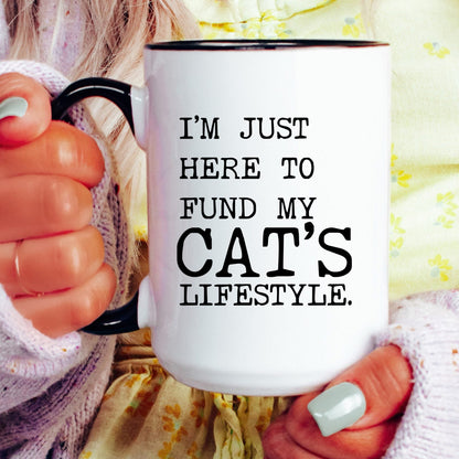 I’m Just Here to Fund My Cat’s Lifestyle coffee mug held by a model
