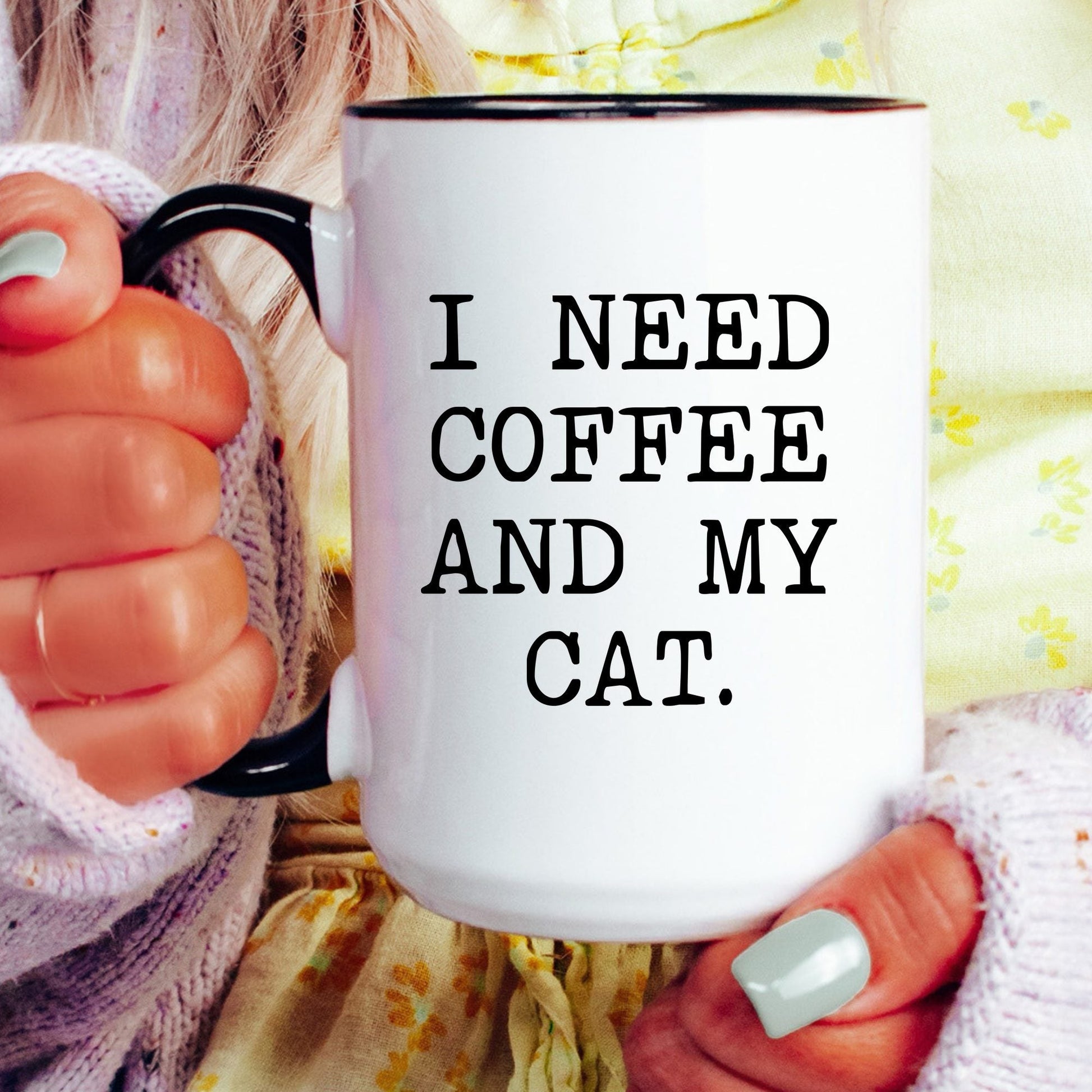 I Need Coffee and My Cat coffee mug held by a model