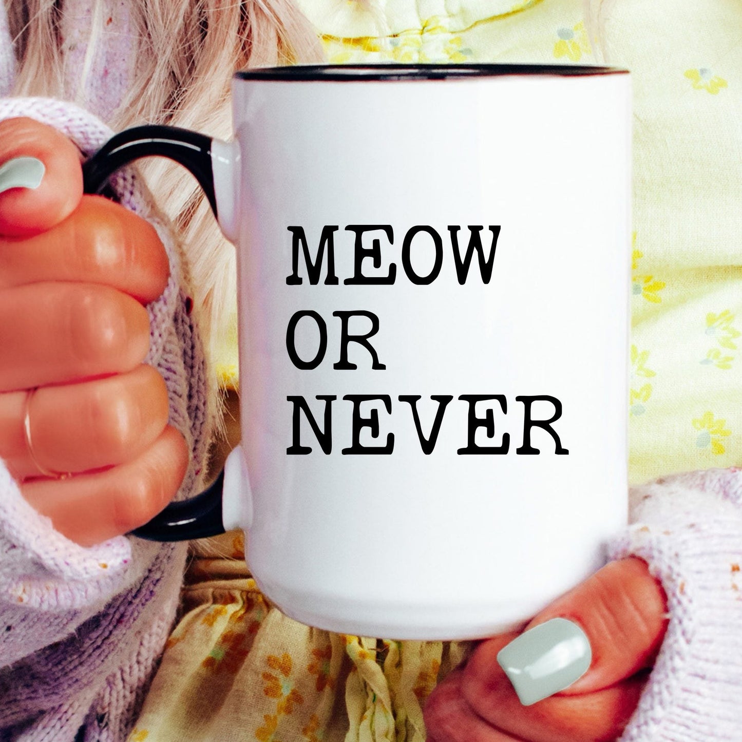 Meow or Never coffee mug held by a model