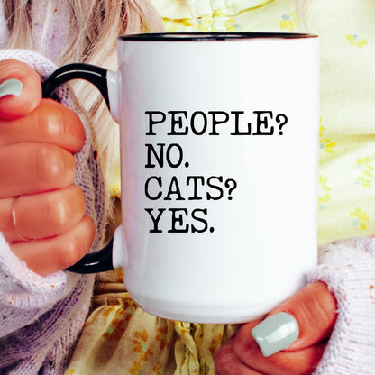 People No Cats Yes coffee mug held by a model