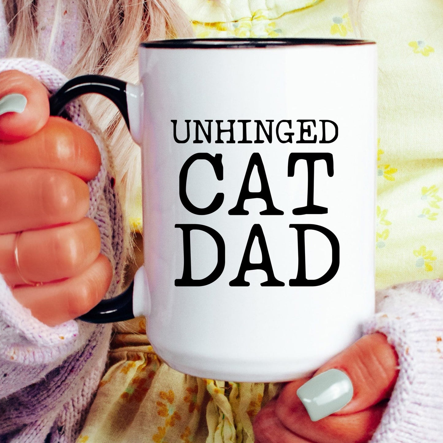Unhinged Cat Dad coffee mug held by a model