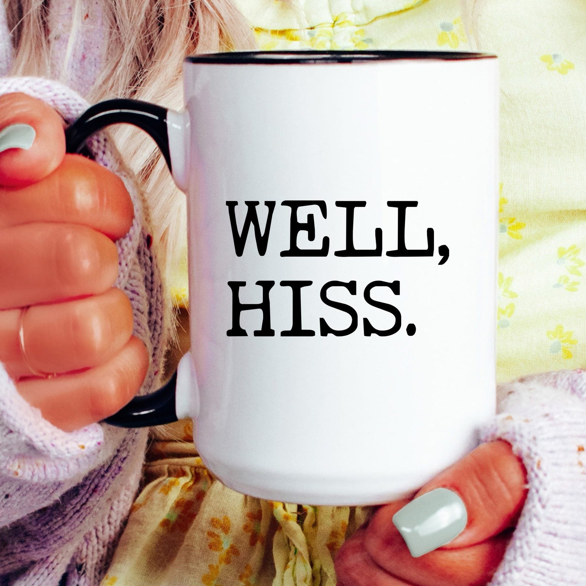 Well Hiss coffee mug held by a model